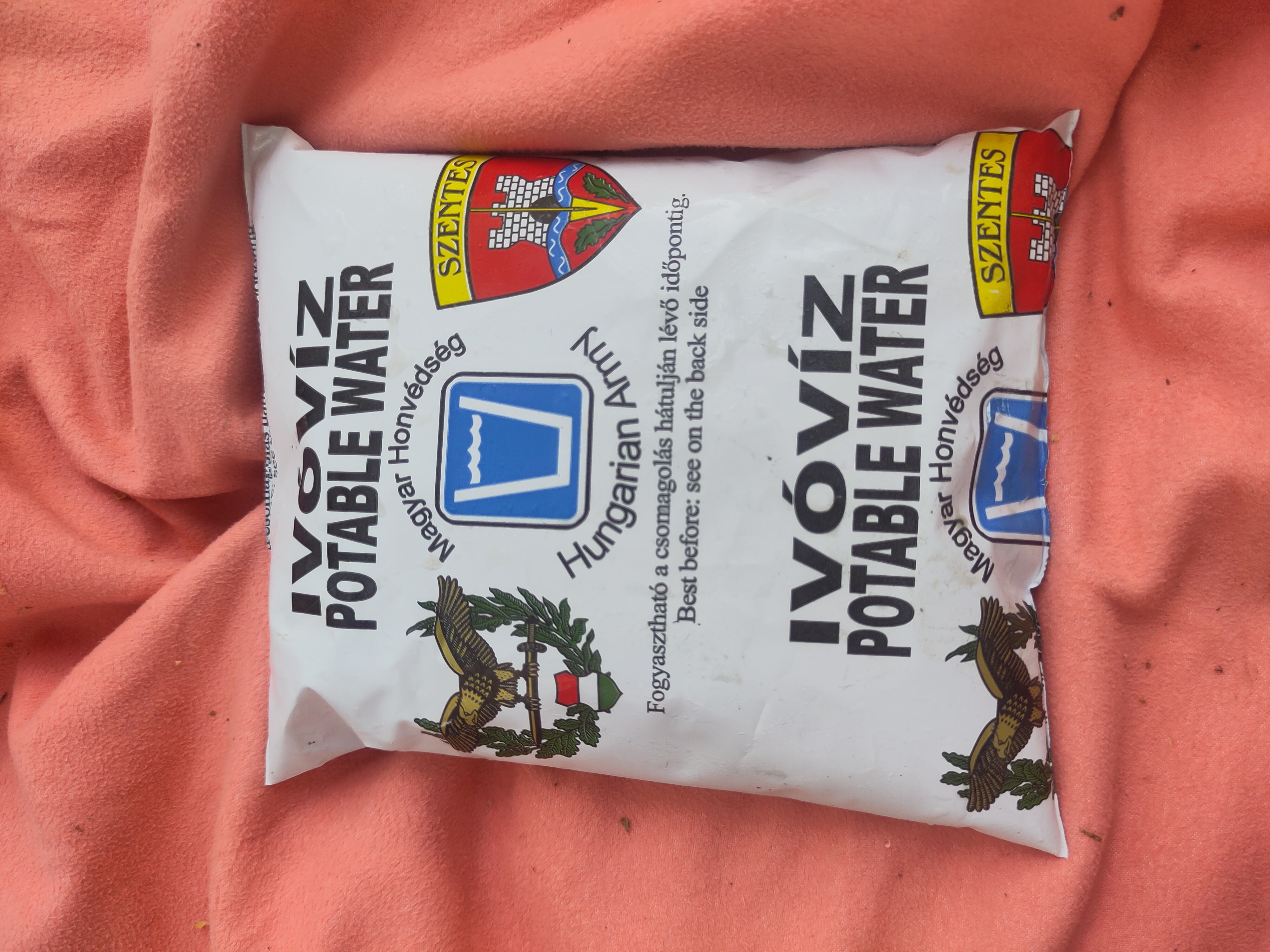 small plastic bag. it has text in hungarian and english: potable water
hungarian army
best before:see on back side
it has the logo of the military and the coat of arms of the city of szentes on it